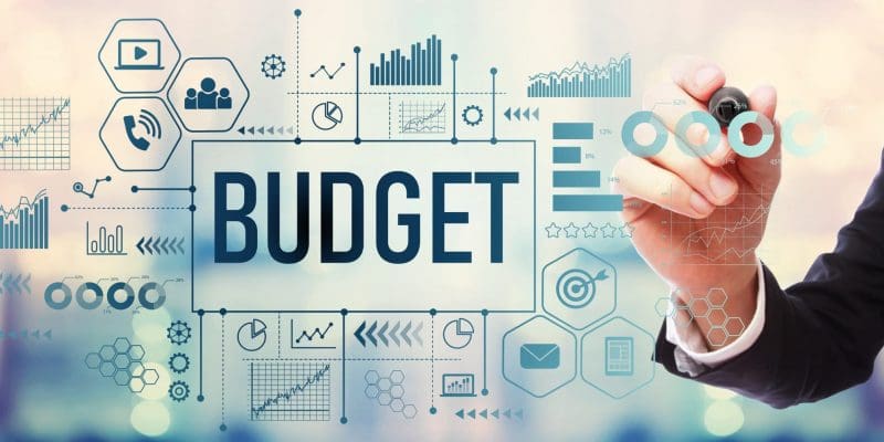 Budget with businessman on blurred abstract background